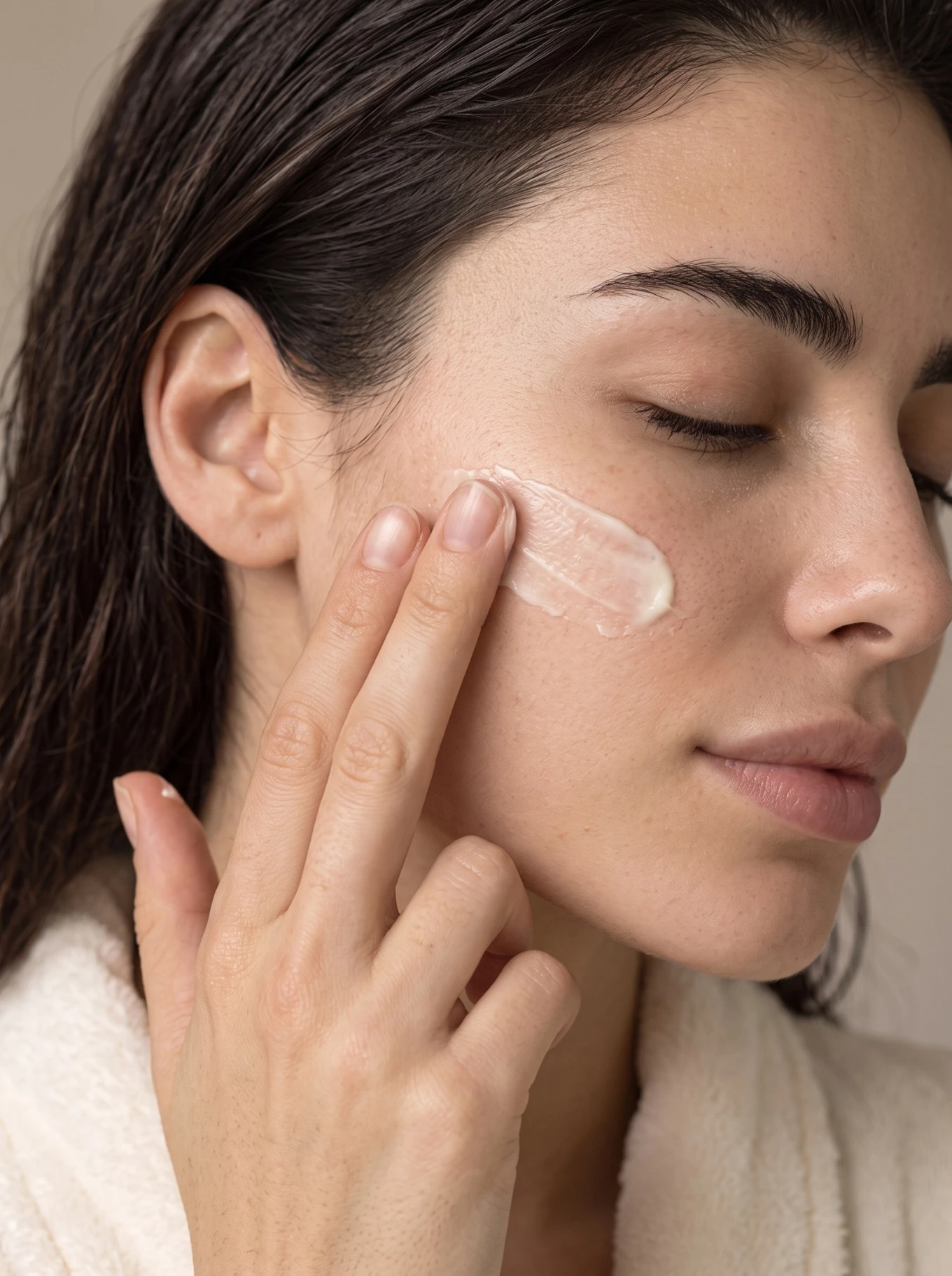 LUMIÈRE skincare concept: close-up of natural skin and cream applied to the cheek